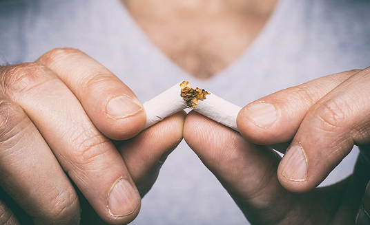Snapping a cigarette in half, symbolising quitting smoking for good in Northbridge